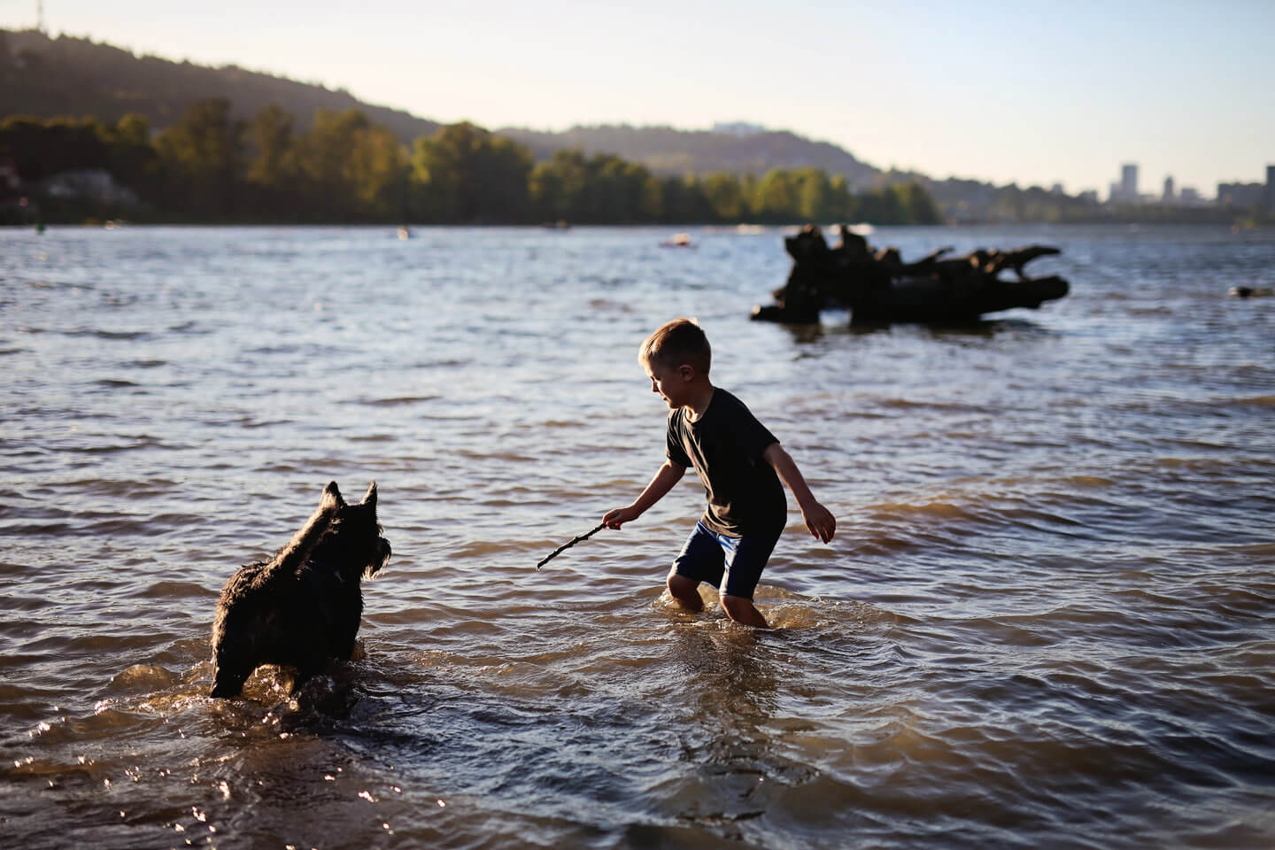 Boy and his dog enjoying time at the Willamette River in Portland, Oregon