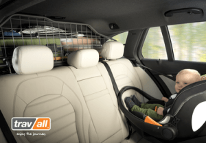 Infant in rear-facing car seat with a Travall Guard installed in a vehicle that has luggage packed in trunk