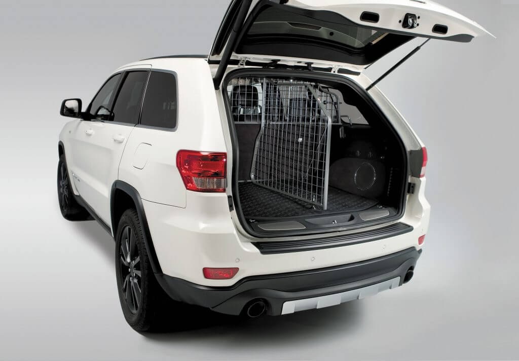 Rear view of a Travall Guard and Divider in a white Jeep Grand Cherokee. 